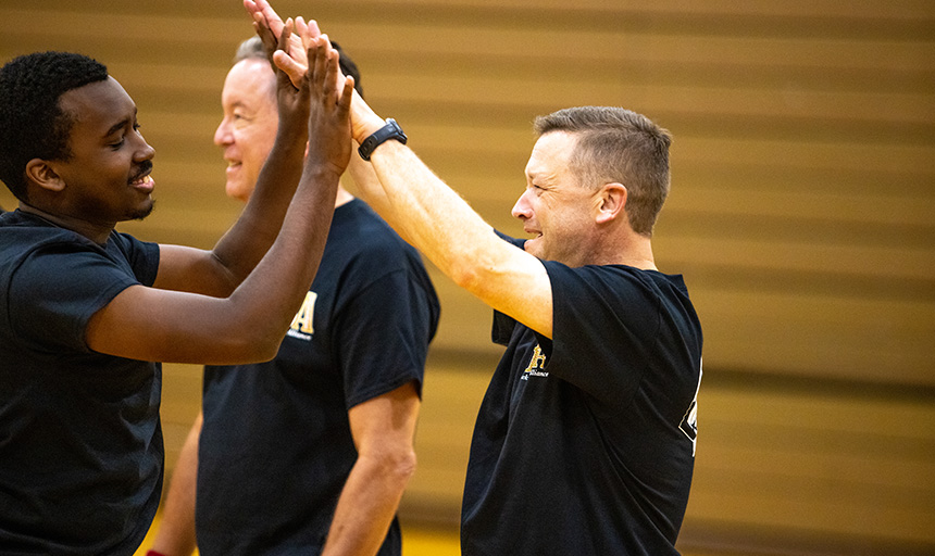 A student high-fives Roanoke College President Shushok at last year's BSA game