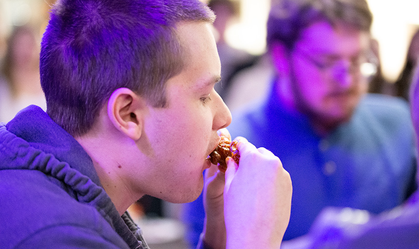 A student enjoying wings.