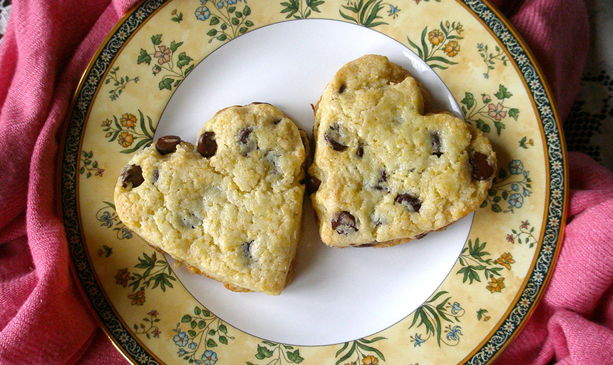 Two heart-shaped cookies on a decorative plate