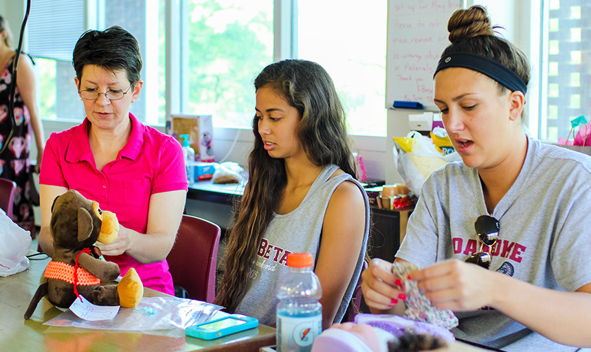 a professor and students work on modifying toys