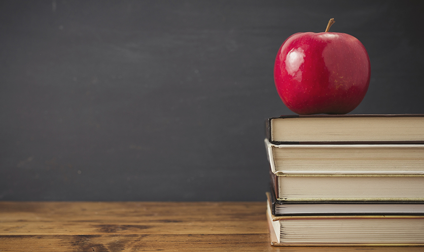 A pile of books and an apple