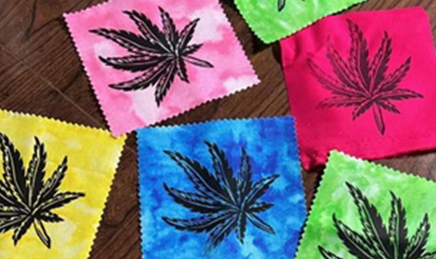 Squares of colorful fabric stamped with cannabis leaf designs