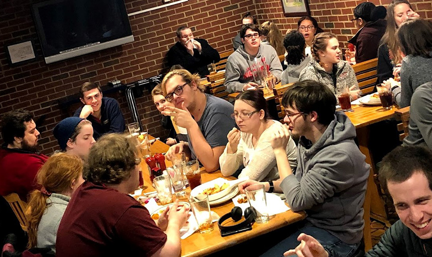 Students gathered around restaurant tables during ToT