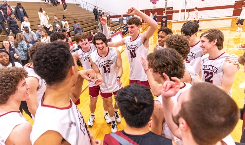 Volleyball team in a huddle during game