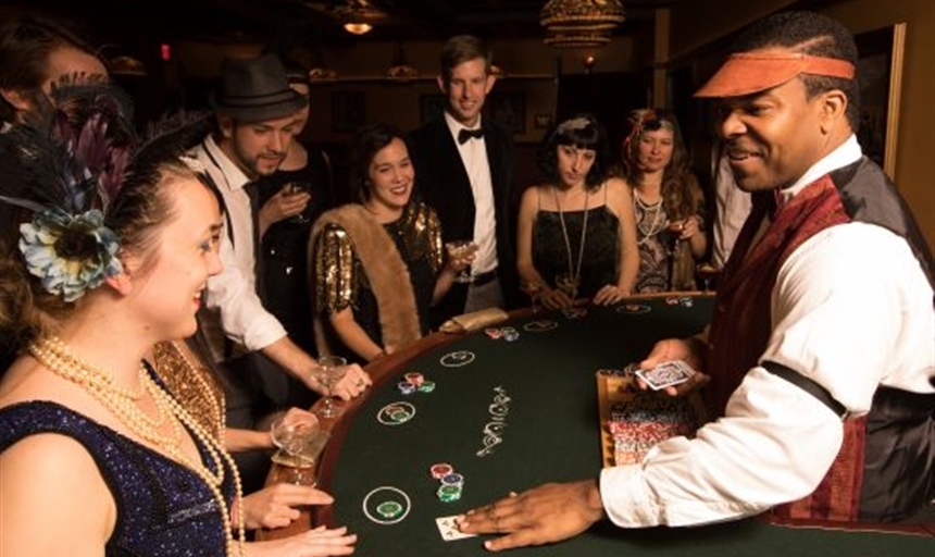 People dressed in Roarin' 20s attire playing Poker at a Speakeasy