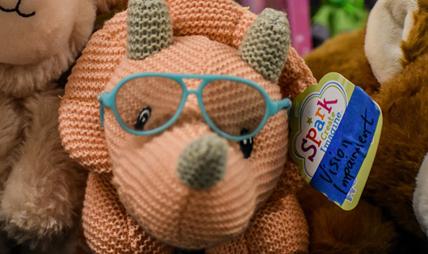 A stuffed dinosaur modified to wear eyeglasses