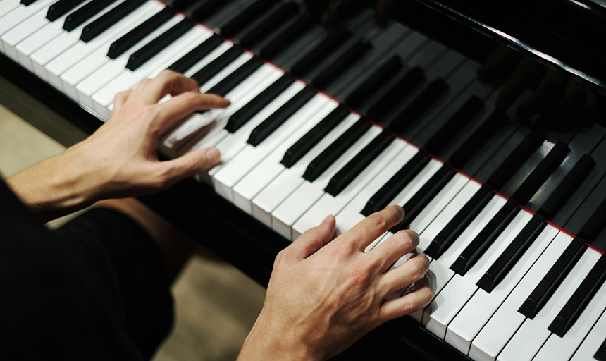 Fingers poised over piano keys