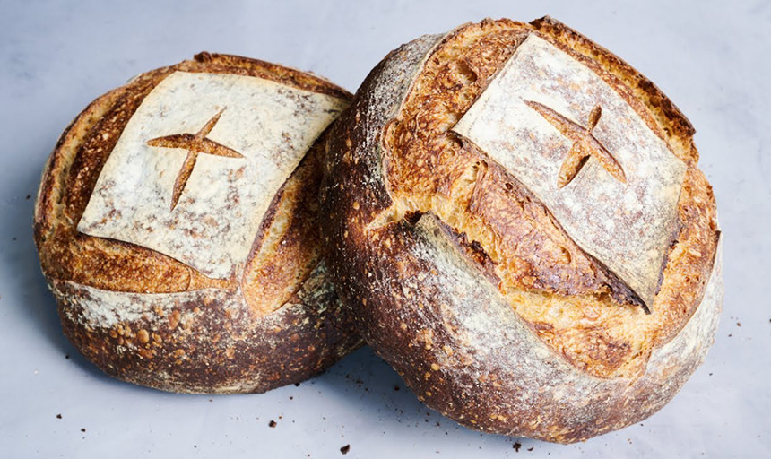 Sourdough bread loaves scored with the sign of the cross