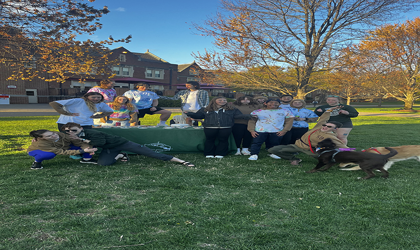 Students in a group posing for a picture on back quad.