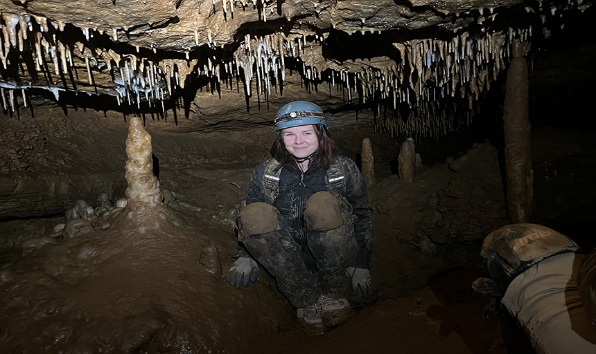 student in a cave.