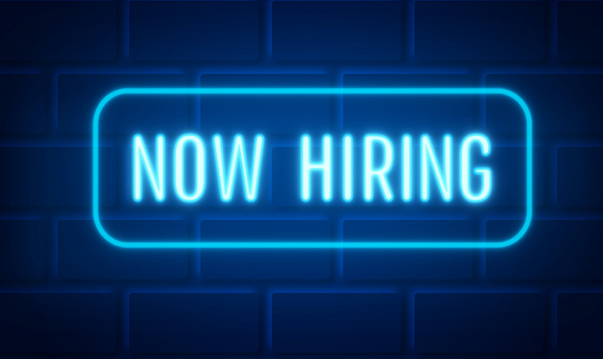 Neon sign with the words: Now Hiring