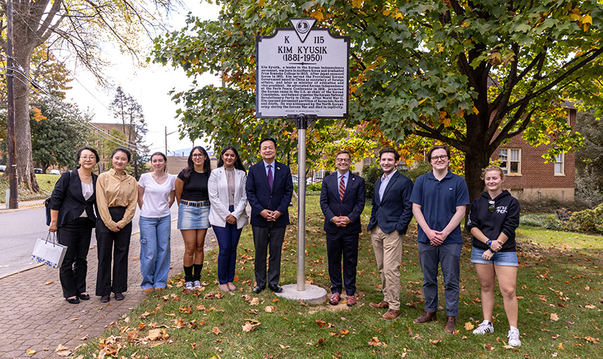 Several people in delegations from Roanoke College and Korean Embassy stand at Kim Kyusik historic marker