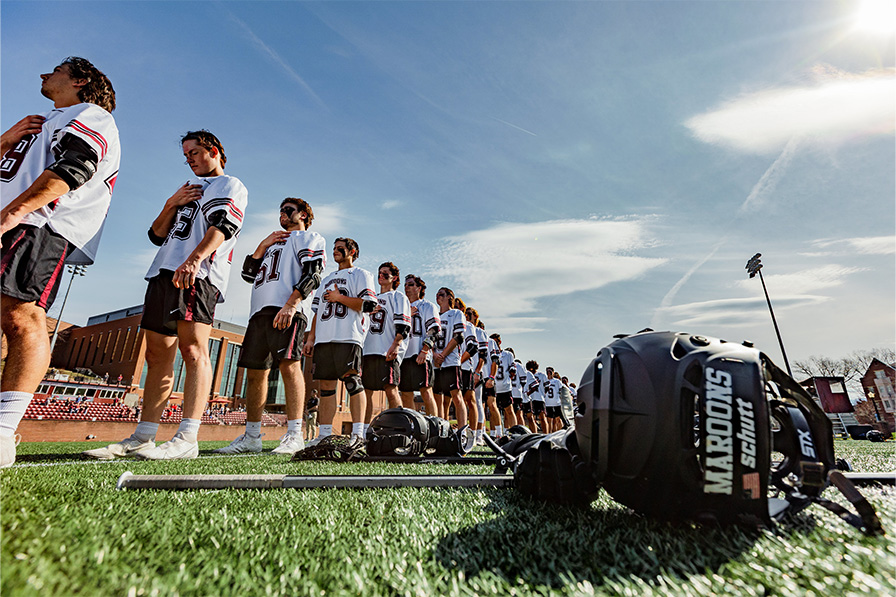 Men's Lacrosse team standing for the national anthem.