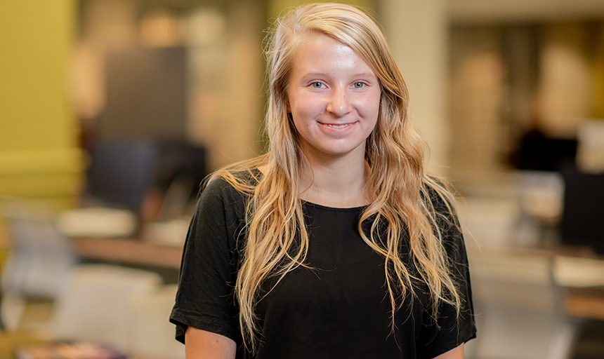 Student standing in the library