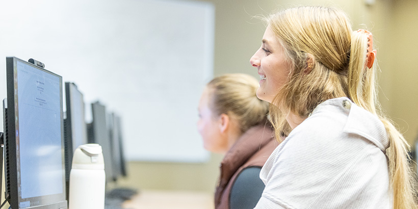 A student smiles during a class discussion