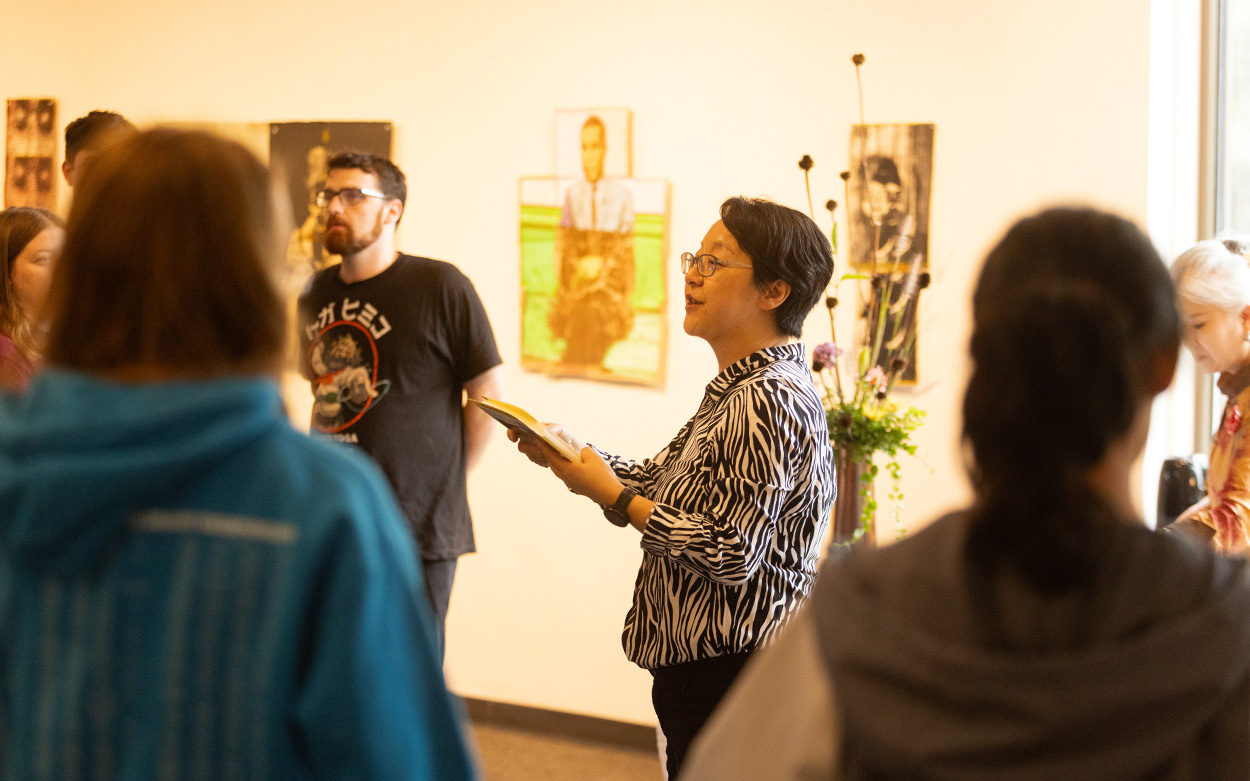 Roanoke College professor speaking to a group of people at the gallery.