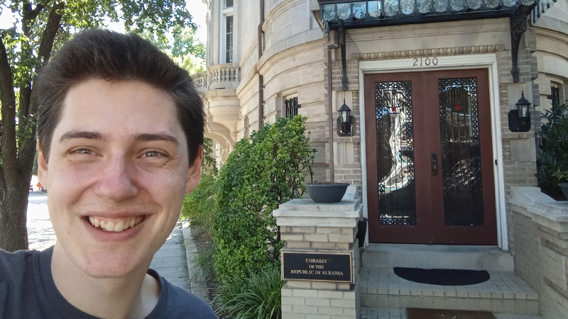 Damien Fellows smiling for a photo on Embassy Row in Washington D.C.