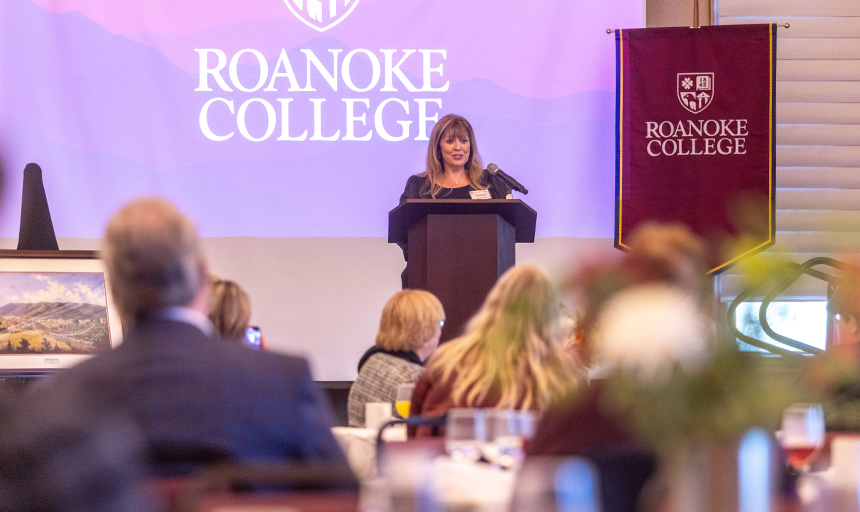 Teresa Sizemore stands at a podium while addressing the audience in Roanoke College's Wortmann Ballroom