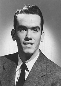 Young man in black and white head shot with suit and tie