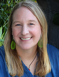 Headshot of a blonde woman in blue shirt