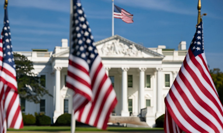 Photo of U.S. flags displayed outside the White House