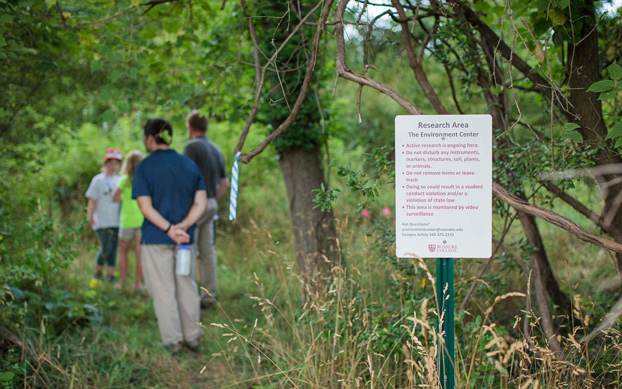 Participants walk in the woods at Suburban Wild event