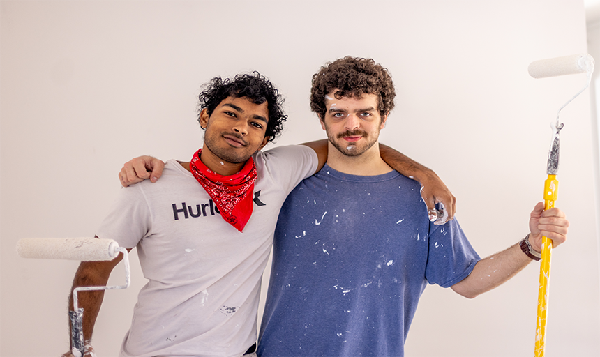 Two friends smiling and posing for a picture.