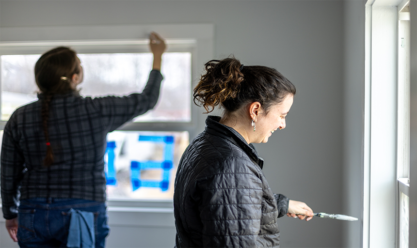 Participants painting the window sill.