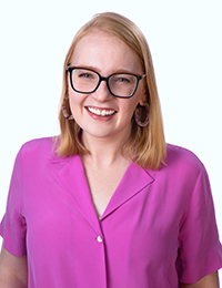 Young blonde woman with glasses in bright pink blouse