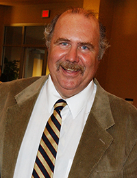 Man with moustache in sport coat and tie