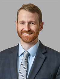 Young man with red beard in a suit and tie