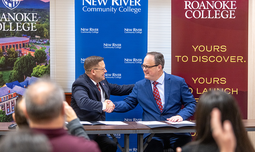 Roanoke President Frank Shushok Jr. shakes hands with New River Community College President Robert Brandon  