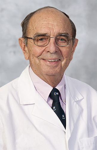 Headshot of man in a tie and white lab coat