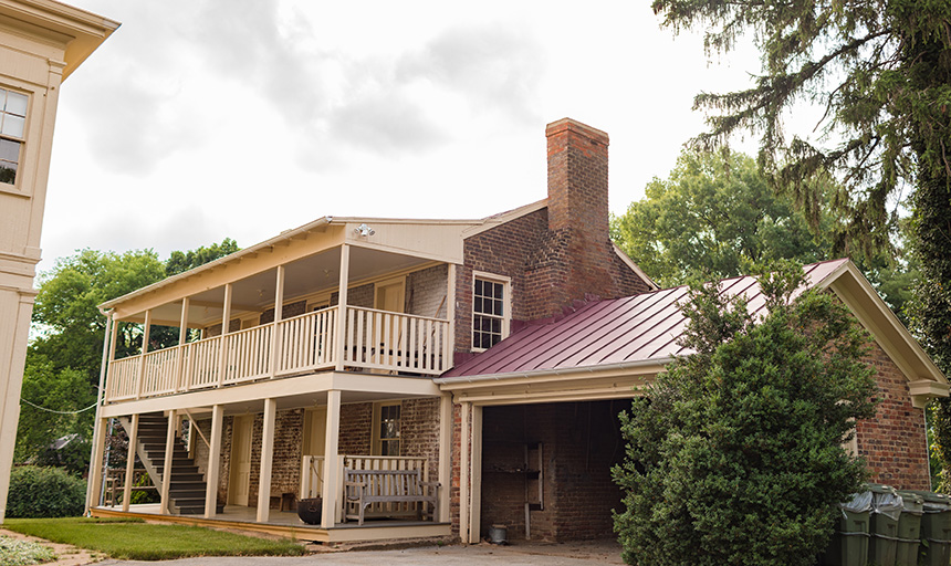 Old brick two-story house with wooden porches