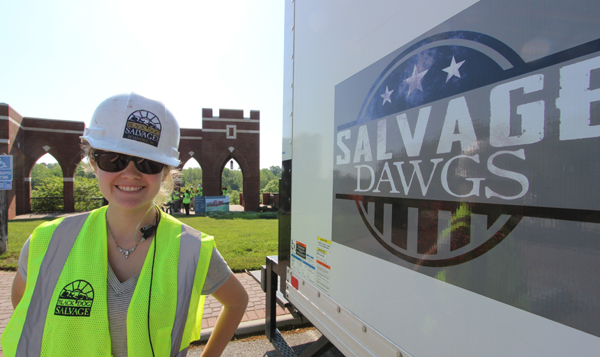 student next to a truck reading "savage dawgs" on the side