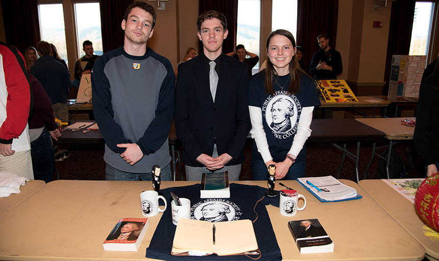 Society members man a booth at a campus event fair