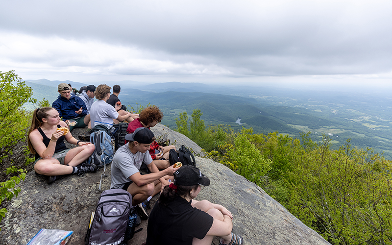 Students resting at the top of a mountain