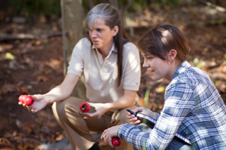 Student and professor working in a forest