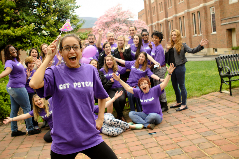 Students and faculty cheer for a photo while wearing t-shirts with the slogan: Get Psyched