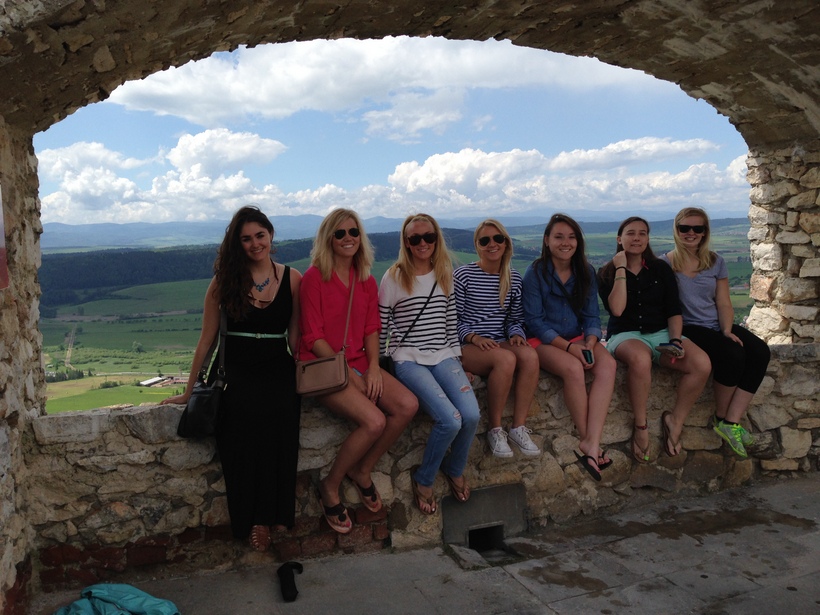 Students sitting on a rock ledge in Slovakia