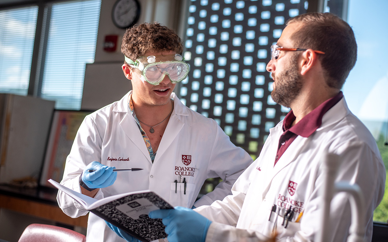 Professor working with students during a lab